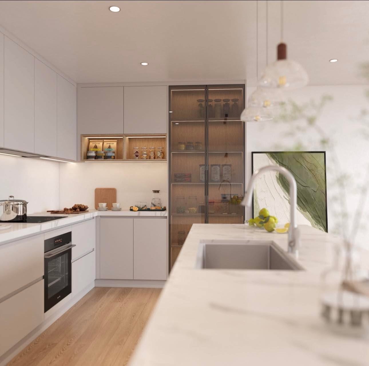 Cuisine minimaliste sur mesure Ebanista : façades sans poignée, niche en bois éclairée, garde-manger vitré toute hauteur et îlot en quartz blanc.